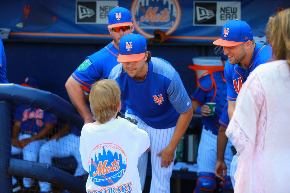 <p>New York Mets pitcher Jacob deGrom and outfielder Tim Tebow listen to a young fan before the baseball game against the Miami Marlins at First Data Field in Port St. Lucie, Fla., March 1, 2018. (Photo: Gordon Donovan/Yahoo News) </p>