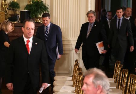 U.S. President Donald Trump's top White House staff, including (L-R) Chief of Staff Reince Priebus, National Security Advisor Michael Flynn, Chief Strategist Steve Bannon and Senior Advisors Stephen Miller and Jared Kushner, enter the East Room to attend a joint news conference being held by President Trump and British Prime Minister Theresa May at the White House in Washington, U.S., January 27, 2017. REUTERS/Carlos Barria - RTSXP8J