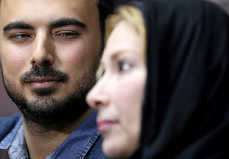 Palestinian journalist, Yaghi, looks at his mother Zouheir as they reunite after 20 years of separation, in Banha