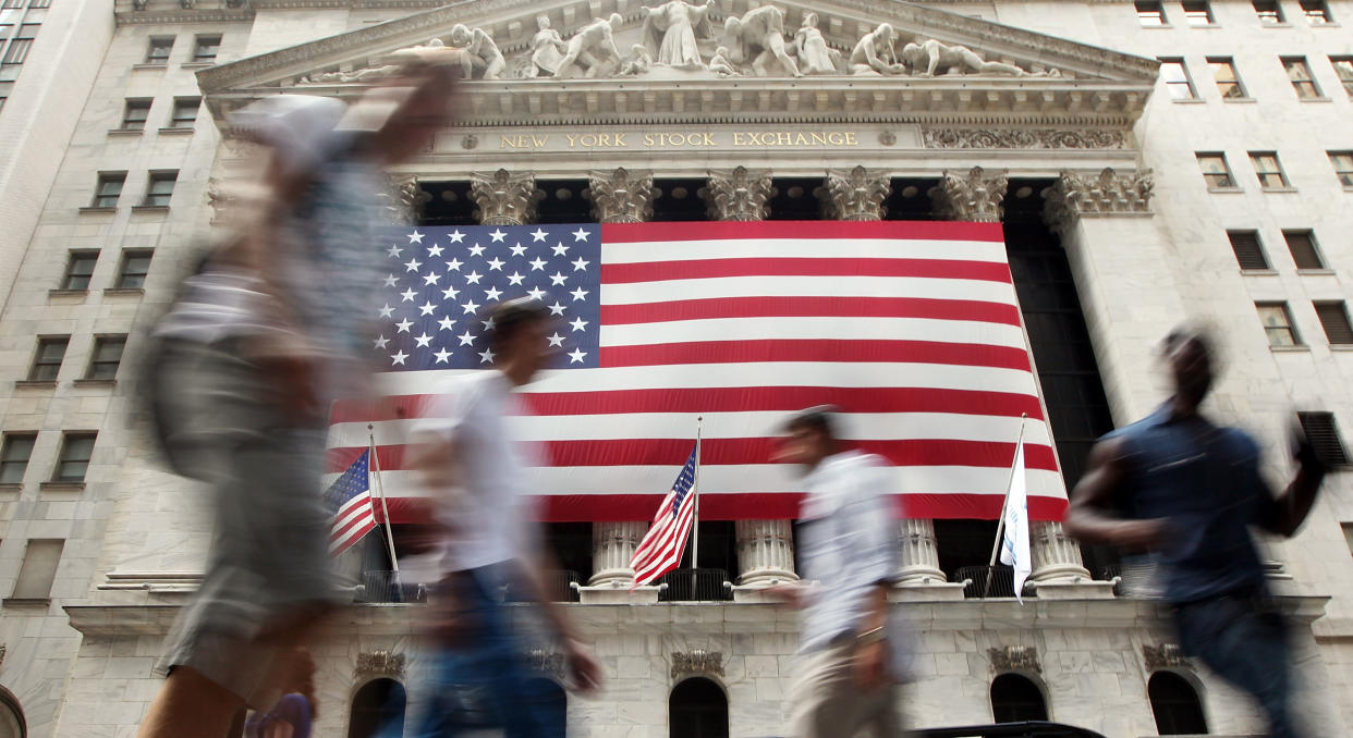 NEW YORK, NY - AUGUST 08:  People walk outside the New York Stock Exchange during afternoon trading on August 8, 2011 in New York City. The Dow plunged more than 500 points in afternoon trading after Standard and Poor's downgraded the U.S. credit rating.  (Photo by Mario Tama/Getty Images)