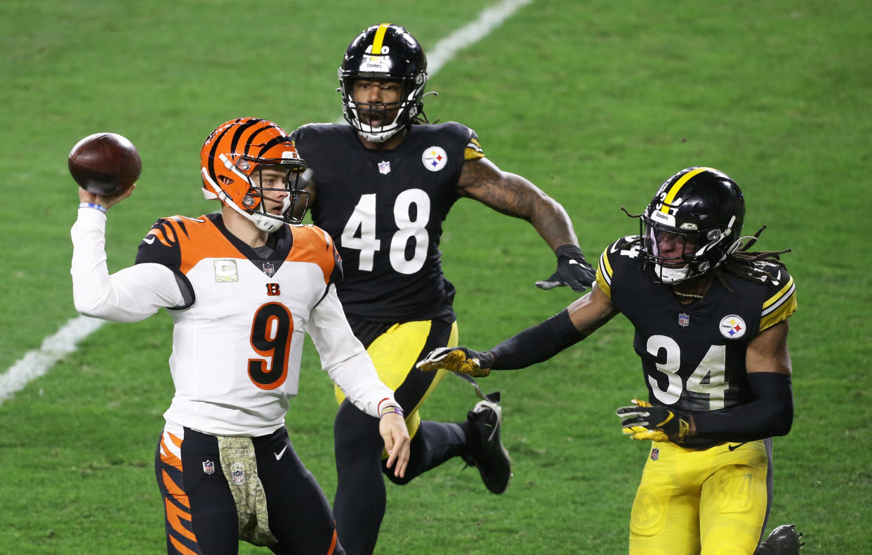 Nov 15, 2020; Pittsburgh, Pennsylvania, USA;  Cincinnati Bengals quarterback Joe Burrow (9) passes under pressure from Pittsburgh Steelers outside linebacker Bud Dupree (48) and strong safety Terrell Edmunds (34) during the second quarter at Heinz Field. Mandatory Credit: Charles LeClaire-USA TODAY Sports