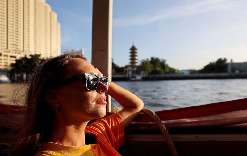 Lillian Smith, 30, from Mississippi, U.S. goes on a city tour at Wat Arun temple in Bangkok