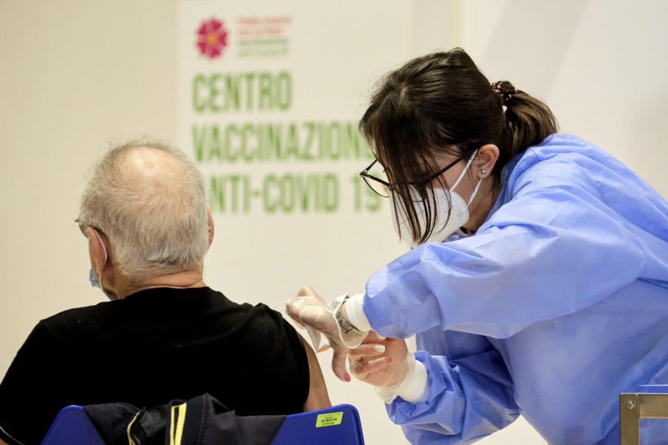 A person receives his shot of vaccine against Covid-19 as the vaccination campaign continues on Easter Day in Rome, Sunday, April 4, 2021. Italy has entered a three-day strict nationwide lockdown to prevent new surges of the coronavirus. Police set up road checks to ensure people were staying close to home and extra patrols were ordered up to break up large gatherings in squares and parks, which over Easter weekend are usually packed with picnic-goers. (Mauro Scrobogna/LaPresse via AP)