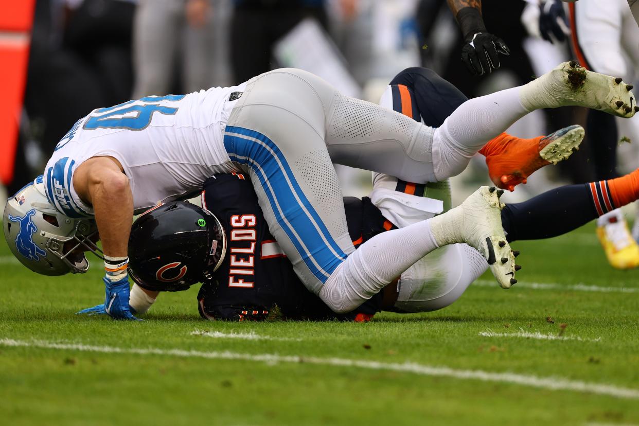 Detroit Lions linebacker Jack Campbell (46) makes a tackle on Chicago Bears quarterback Justin Fields (1) during the first half at Soldier Field.