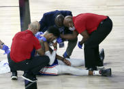 Philadelphia 76ers forward Tobias Harris is attended to after hitting his head against the Boston Celtics during the third quarter of Game 4 of an NBA basketball first-round playoff series, Sunday, Aug. 23, 2020, in Lake Buena Vista, Fla. (Kim Klement/Pool Photo via AP)