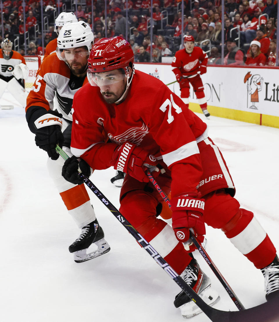 Detroit Red Wings center Dylan Larkin (71) is pressured by Philadelphia Flyers center Ryan Poehling (25) during the second period of an NHL hockey game Friday, Dec. 22, 2023, in Detroit. (AP Photo/Duane Burleson)