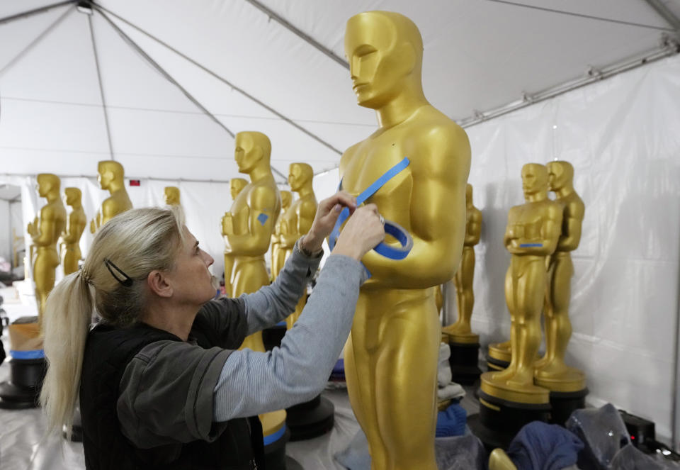 Antje Menikheim, lead scenic painter for Sunday's 95th Academy Awards, readies an Oscar statue for the event, Wednesday, March 8, 2023, near the Dolby Theatre in Los Angeles. (AP Photo/Chris Pizzello)