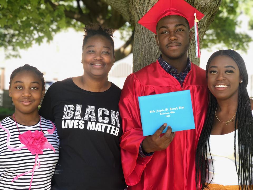 McMillian beams with pride as son Jalen holds up his high school diploma. (Photo: Lakishia McMillian)