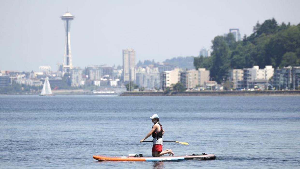 <div>A paddle boarder is pictured at Alki Beach.</div> <strong>(JASON REDMOND/AFP via Getty Images)</strong>