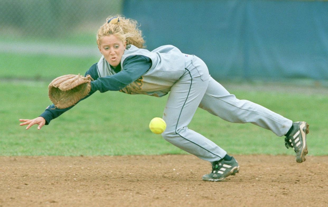 University of Akron second baseman Tracee McCoy-Jenkins makes a diving stop on a ball hit by Kent State's Denae Jones in 2000. McCoy-Jenkins will be inducted into the Akron Public Schools Athletics Hall of Fame on Oct. 5.