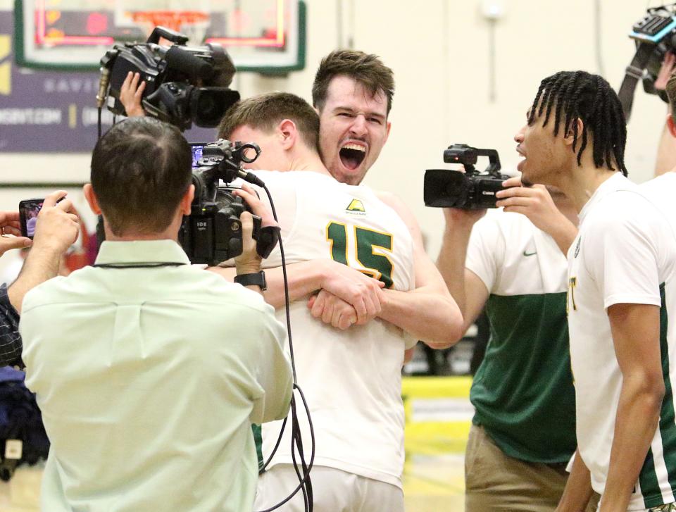 Matt Veretto and Finn Sullivan embrace after winning the America East championship on March 11, 2023 at Patrick Gym.