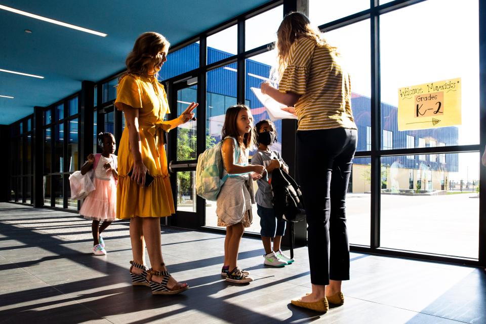 Parents drop off students at brand new John S. McCain III Elementary School on the first day of school in Buckeye, AZ, Aug. 4, 2021. Benjamin Chambers/The Republic