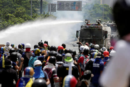 A jet of water is released on demonstrators during a rally against Venezuela's President Nicolas Maduro in Caracas, Venezuela, May 26, 2017. REUTERS/Marco Bello