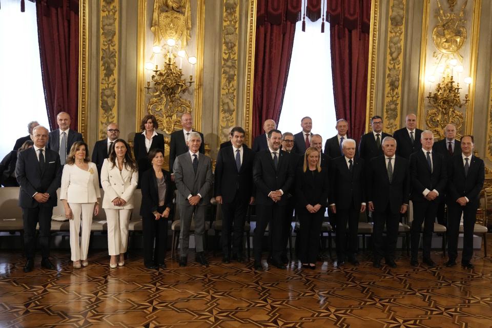 Newly sworn in Italian Premier Giorgia Meloni, center, and her Cabinet pose for a family photo at Quirinal presidential palace in Rome, Saturday, Oct. 22, 2022. Meloni assembled the country's first far-right-led government since the end of World War II and becoming the first woman to obtain the premiership. (AP Photo/Alessandra Tarantino)