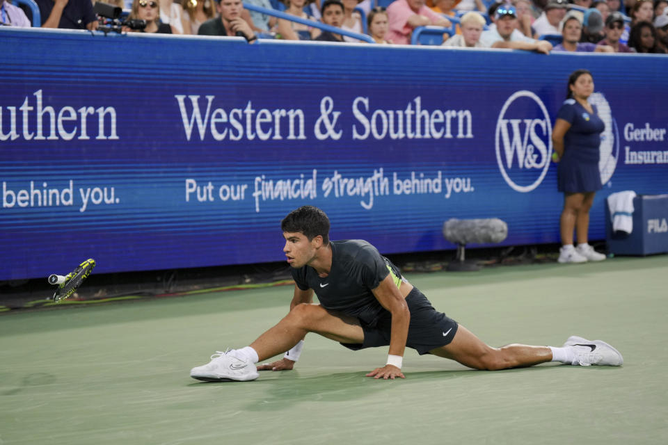 Carlos Alcaraz, of Spain, loses his racquet as he is unable to return a shot to Novak Djokovic, of Serbia, during the men's singles final of the Western & Southern Open tennis tournament, Sunday, Aug. 20, 2023, in Mason, Ohio. (AP Photo/Aaron Doster)