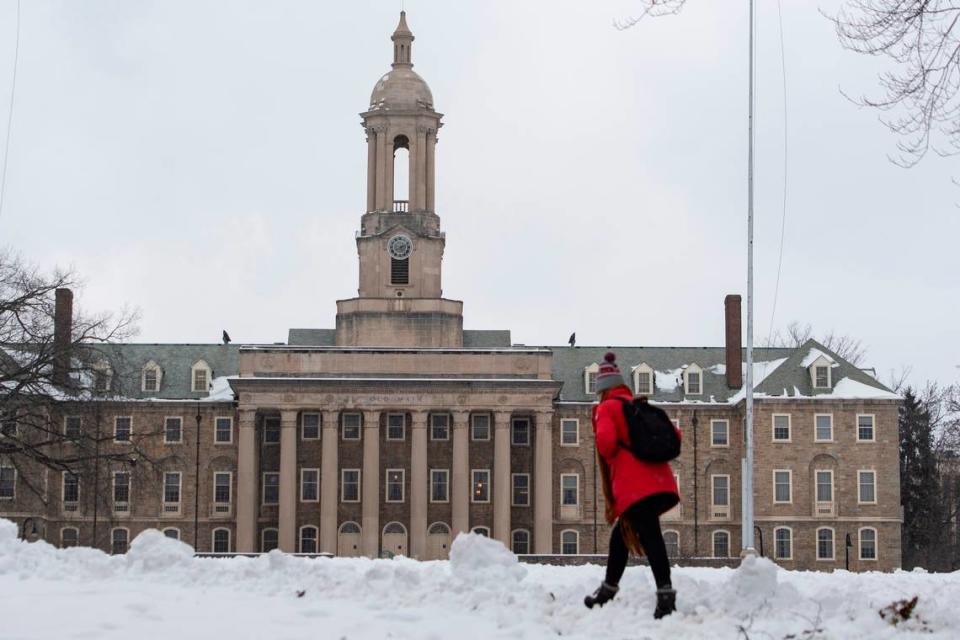 A student walks in front of Penn State’s Old Main on Tuesday in University Park.