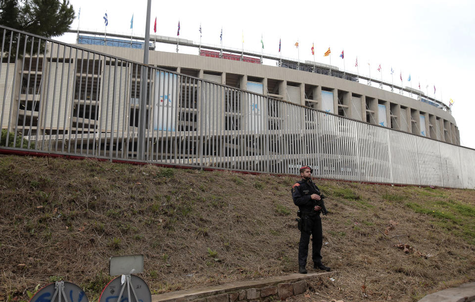 Catalan police officers take positions outside the Camp Nou stadium ahead of a Spanish La Liga soccer match between Barcelona and Real Madrid in Barcelona, Spain, Wednesday, Dec. 18, 2019. Thousands of Catalan separatists are planning to protest around and inside Barcelona's Camp Nou Stadium during Wednesday's match against fierce rival Real Madrid. (AP Photo/Joan Mateu)