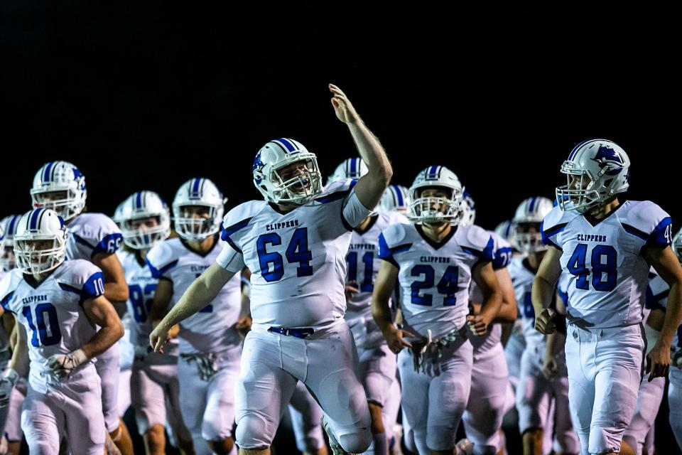 Clear Creek Amana center Tyler Stienes (64) pumps up the crowd while running onto the field before a Class 4A varsity football game against Cedar Rapids Xavier, Friday, Oct. 8, 2021, at Saints Field in Cedar Rapids, Iowa.