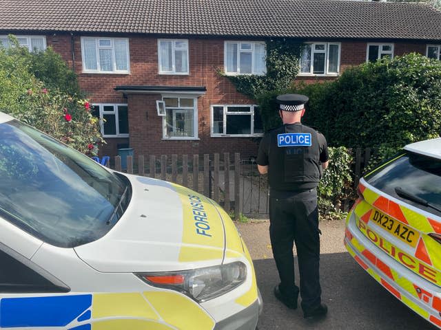 A policeman stands outside the scene of a dog attack in Stonnall