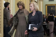 Sen. Lisa Murkowski, R-Alaska, walks with Sen. Kirsten Gillibrand, D-N.Y., right, to the Senate chamber during the impeachment trial of President Donald Trump at the Capitol, Wednesday, Jan. 22, 2020, in Washington. (AP Photo/Steve Helber)