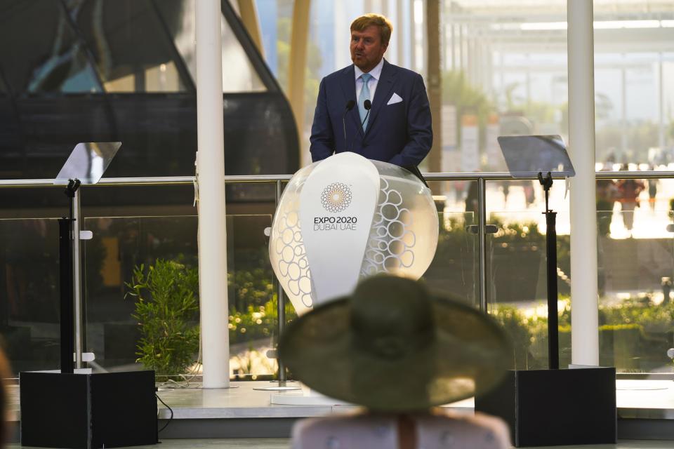 King Willem-Alexander gives a speech as Queen Maxima listens at Expo 2020 in Dubai, United Arab Emirates, Wednesday, Nov. 3, 2021. King Willem-Alexander and Queen Maxima of the Netherlands are in the United Arab Emirates as part of a royal trip to the country to visit Dubai's Expo 2020. (AP Photo/Jon Gambrell)