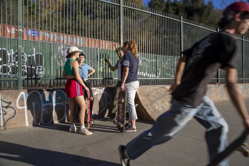 SOUTH PASADENA, CA - November 14 2021: Members of the Aunt Skatie crew, left, gather at the South Pasadena Skate Park on Sunday, Nov. 14, 2021 in South Pasadena, CA. (Brian van der Brug / Los Angeles Times