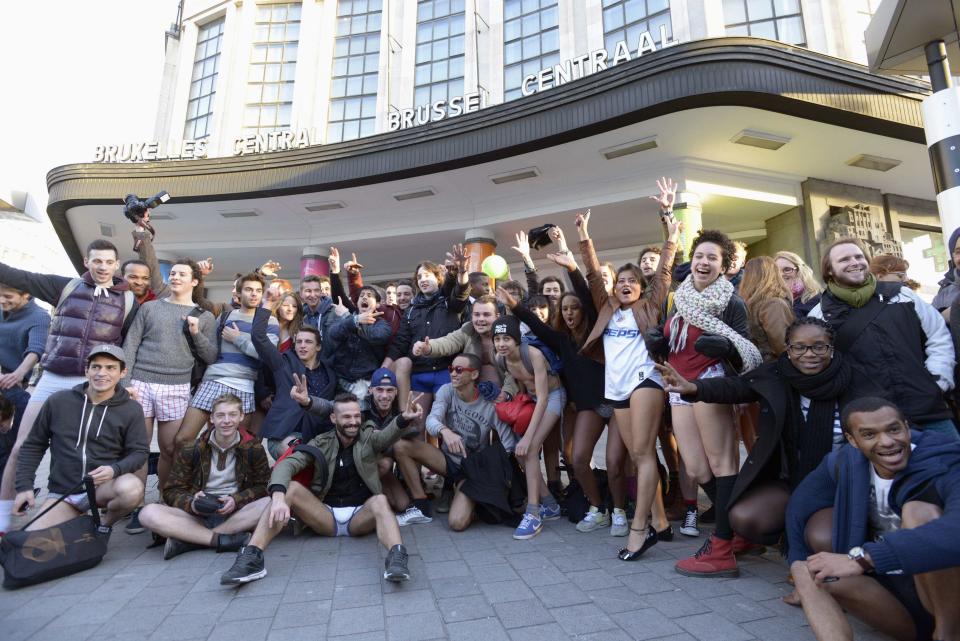 People pose for a photo as they take part in the annual "No Pants Subway Ride" celebrations on the streets of Brussels January 12, 2014. The event involves participants who strip down to their underwear as they go about their normal routine, and occurs in different cities around the world in January, according to its organisers. REUTERS/Eric Vidal (BELGIUM - Tags: TRANSPORT SOCIETY ANNIVERSARY)