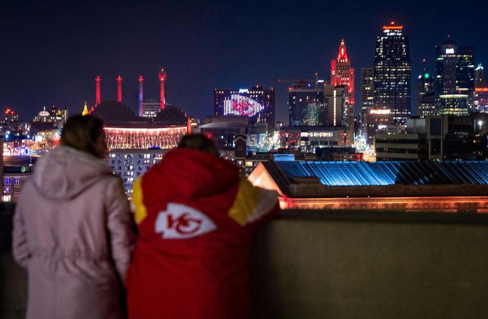 Nicole Haug, left, and her mother Debbie Haug study the Kansas City skyline with its red glowing buildings to celebrated the success of the Kansas City Chiefs while they stood on the deck at Liberty Memorial on Friday, January 29, 2021.