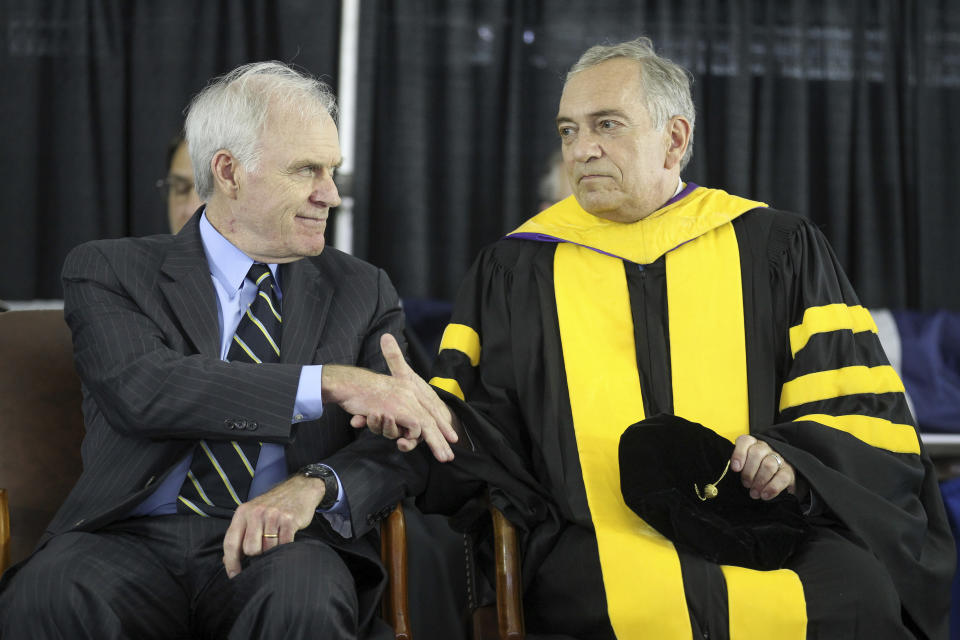 Secretary of the Navy Richard Spencer, left, shakes hands with Acting President of the U.S. Naval War College Dr. Lewis Duncan, during the U.S. Naval War College's commencement ceremony, Friday, June 14, 2019, in Newport, R.I. (AP Photo/Stew Milne)