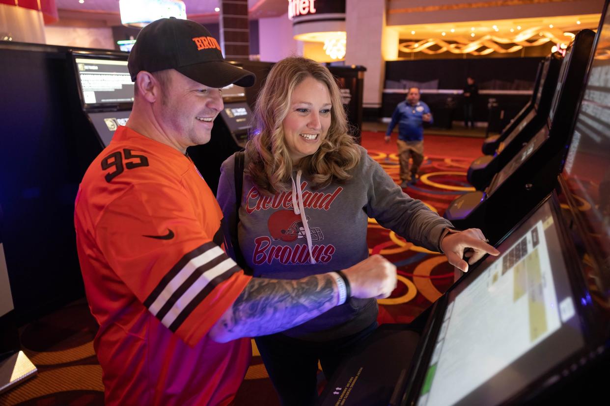 Joe George and his wife, Stephanie, both of Parma, try out one of the sports betting kiosks inside the MGM Northfield Park’s BetMGM Sportsbook & Lounge on the first day of legalized sports betting in Ohio on Jan. 1, 2023.