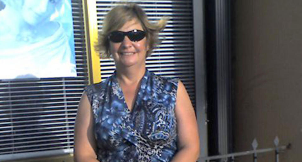 Beatrix Searles is seen wearing sunglasses and smiling. She said the surgery has ruined her life.