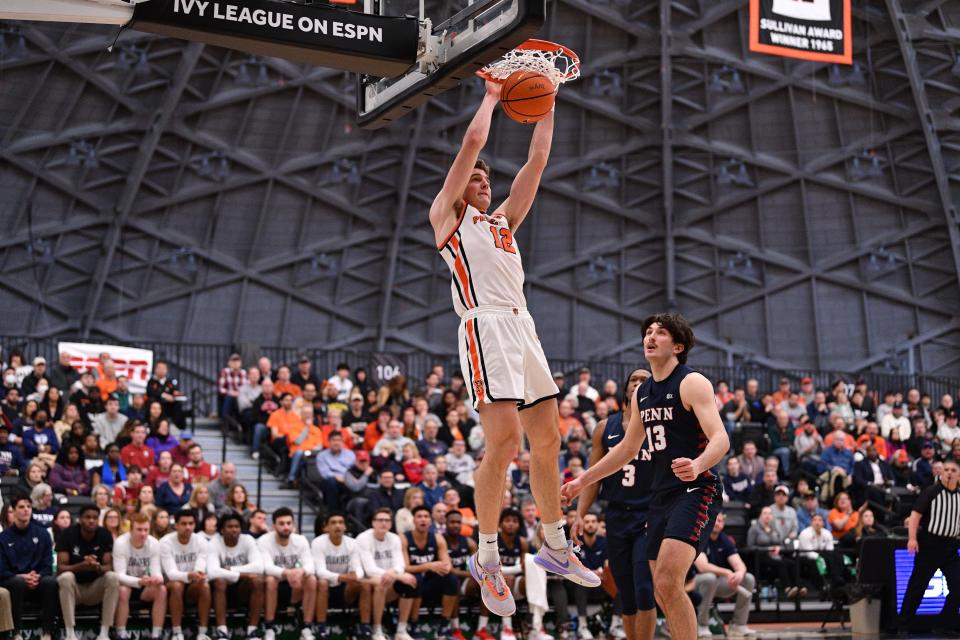 Princeton's Caden Pierce dunks against Penn