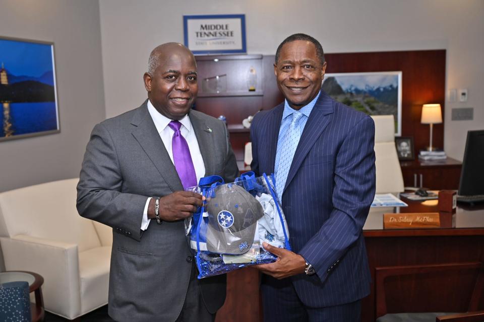 MTSU President Sidney A. McPhee, right, presents a collection of MTSU swag as a welcoming gift to the Honorable Philip Edward Davis, prime minister and minister of finance for the Bahamas, inside the President’s Office in the Cope Administration Building Friday, May 6, on the MTSU campus. Davis will be keynote speaker for the Saturday morning spring commencement ceremony at Murphy Center, where he will also receive an honorary doctorate degree.