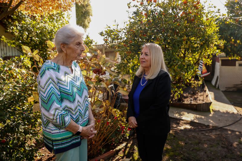 Janet Pygeorge and Janet Callaghan, talk together outside Pygeorge's home in Rodeo, CA