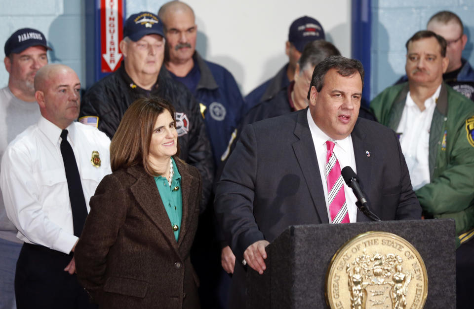 New Jersey Gov. Chris Christie, right, stands next to his wife, Mary Pat Christie, left, and a group of first responders while talking during a news conference at at fire house, Monday, Nov. 26, 2012, in Middletown, N.J. Christie announced he will seek re-election to a second term. Christie says he want New Jerseyans to know that he's "in this for the long haul" as he leads the state's recovery from Superstorm Sandy. (AP Photo/Julio Cortez)