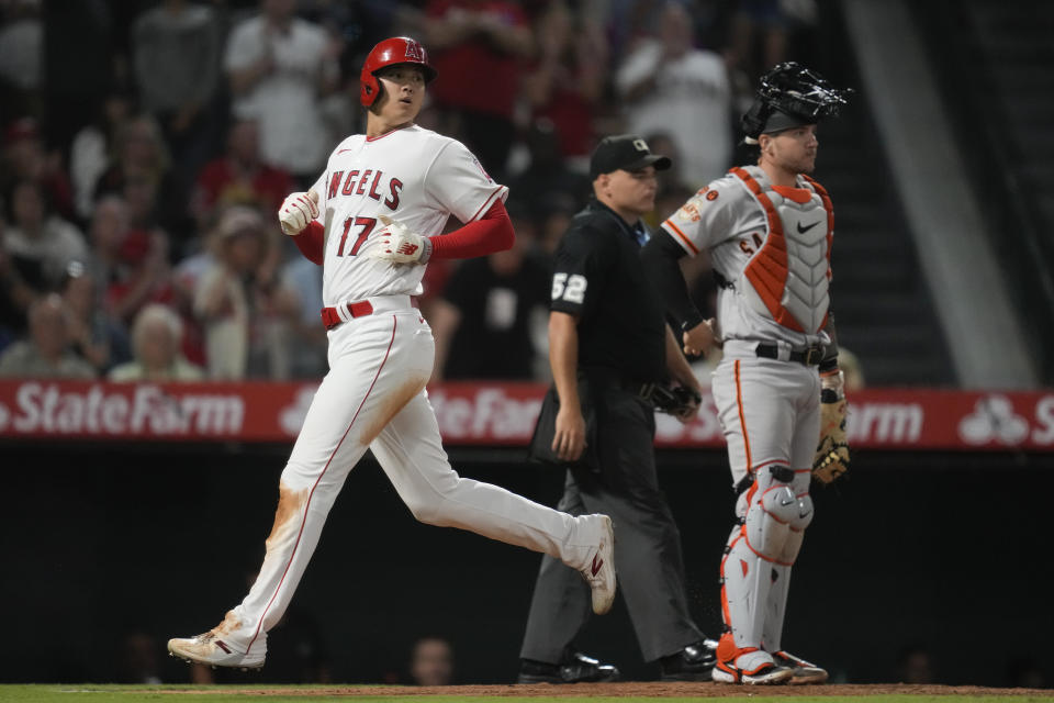 Los Angeles Angels designated hitter Shohei Ohtani (17) scores off of a single hit by C.J. Cron during the sixth inning of a baseball game against the San Francisco Giants in Anaheim, Calif., Monday, Aug. 7, 2023. (AP Photo/Ashley Landis)