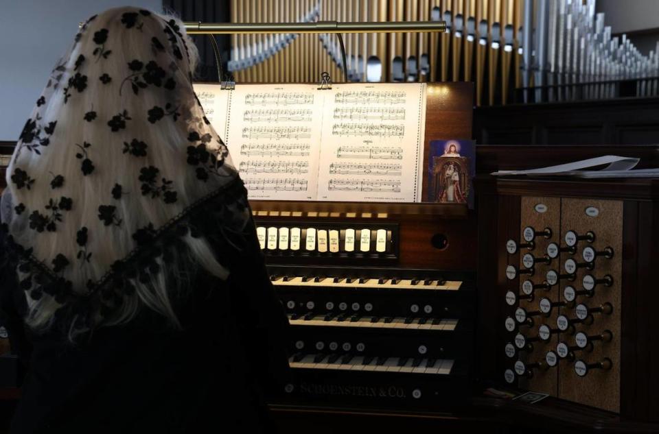 An organist plays the credos while the choir sings in Latin. Congregants of Our Lady of Belen Chapel attended Sunday morning Latin mass as the service attracts young worshipers and families on Sunday, July 30, 2023.