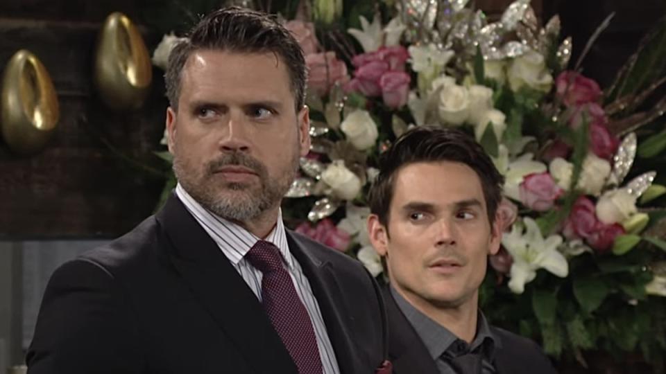 Joshua Morrow and Mark Grossman as Nick and Adam standing next to each other in The Young and the Restless