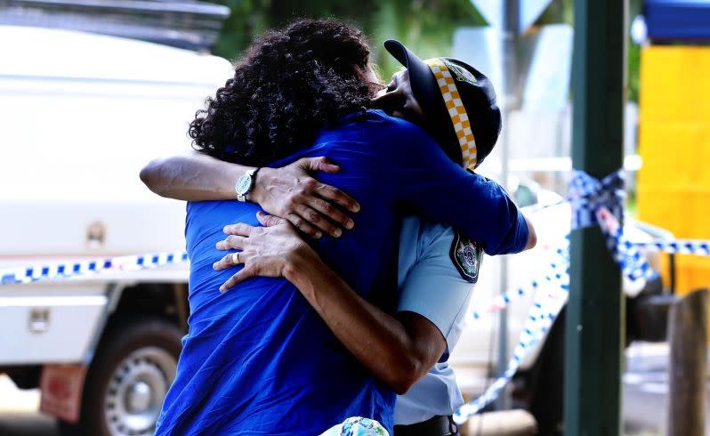 Francece O'Rourke  is comforted by a police officer after leaving floral tribute  to slain children.Picture: Nic Ellis/The West Australian