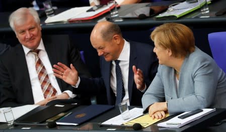 German Finance Minister Olaf Scholz reacts at the lower house of parliament (Bundestag) during a budget session in Berlin