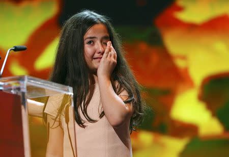 The niece of Iranian film director Jafar Panahi cries as she accepts the Golden Bear for Best Film on her uncle's behalf during the awards ceremony at the 65th Berlinale International Film Festival in Berlin February 14, 2015. REUTERS/Hannibal Hanschke