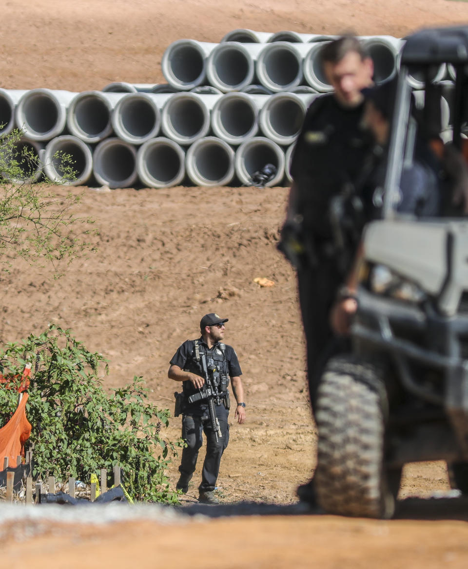 Law enforcement personnel stand at the site of Atlanta's proposed public safety training center, Thursday, Sept. 7, 2023, in DeKalb County, Ga., after several protesters chained themselves to construction equipment in an effort to halt work. (John Spink/Atlanta Journal-Constitution via AP)