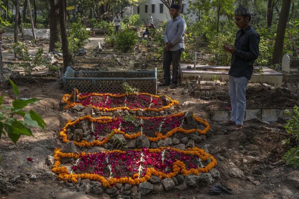 Tanishq Makwana offers prayers at the grave of his cousin, grandmother and aunt who died in a bridge that collapsed on Sunday, at a graveyard in Morbi town of western state Gujarat, India, Tuesday, Nov. 1, 2022. Sunday’s tragedy in Morbi has left the entire country shocked, with questions raised over why the pedestrian bridge, built during British colonialism in the late 1800s and touted by the state government as an “artistic and technological marvel,” collapsed just four days after months of repair. (AP Photo/Rafiq Maqbool)