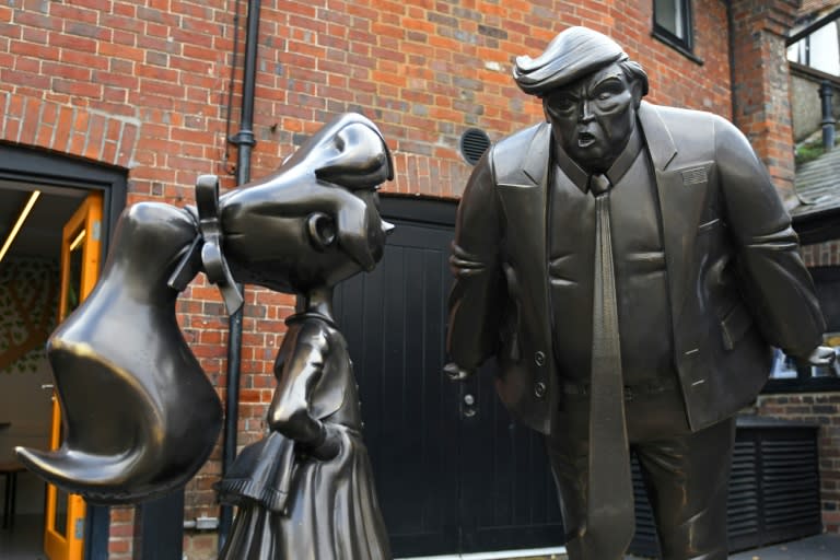 A sculpture of Roald Dahl character Matilda is seen next to one of US President Donald Trump at the newly renovated Roald Dahl Museum