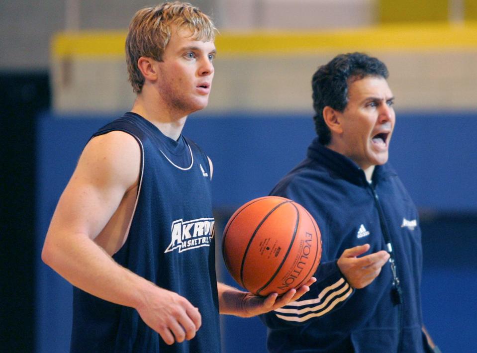 Akron guard Nick Dials listens intently as head coach Keith Dambrot directs practice, Friday, Nov. 11, 2005.