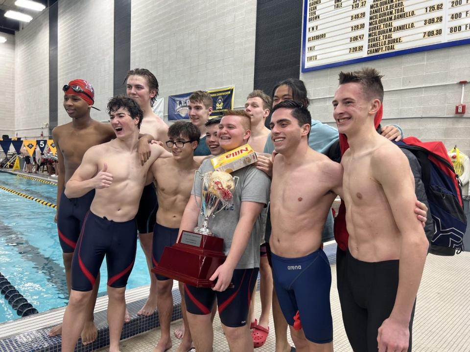 Members of the 2022-23 Bridgewater-Raynham boys swim team pose with the Southeast Conference Championship trophy after winning the league championship meet at UMass Dartmouth.