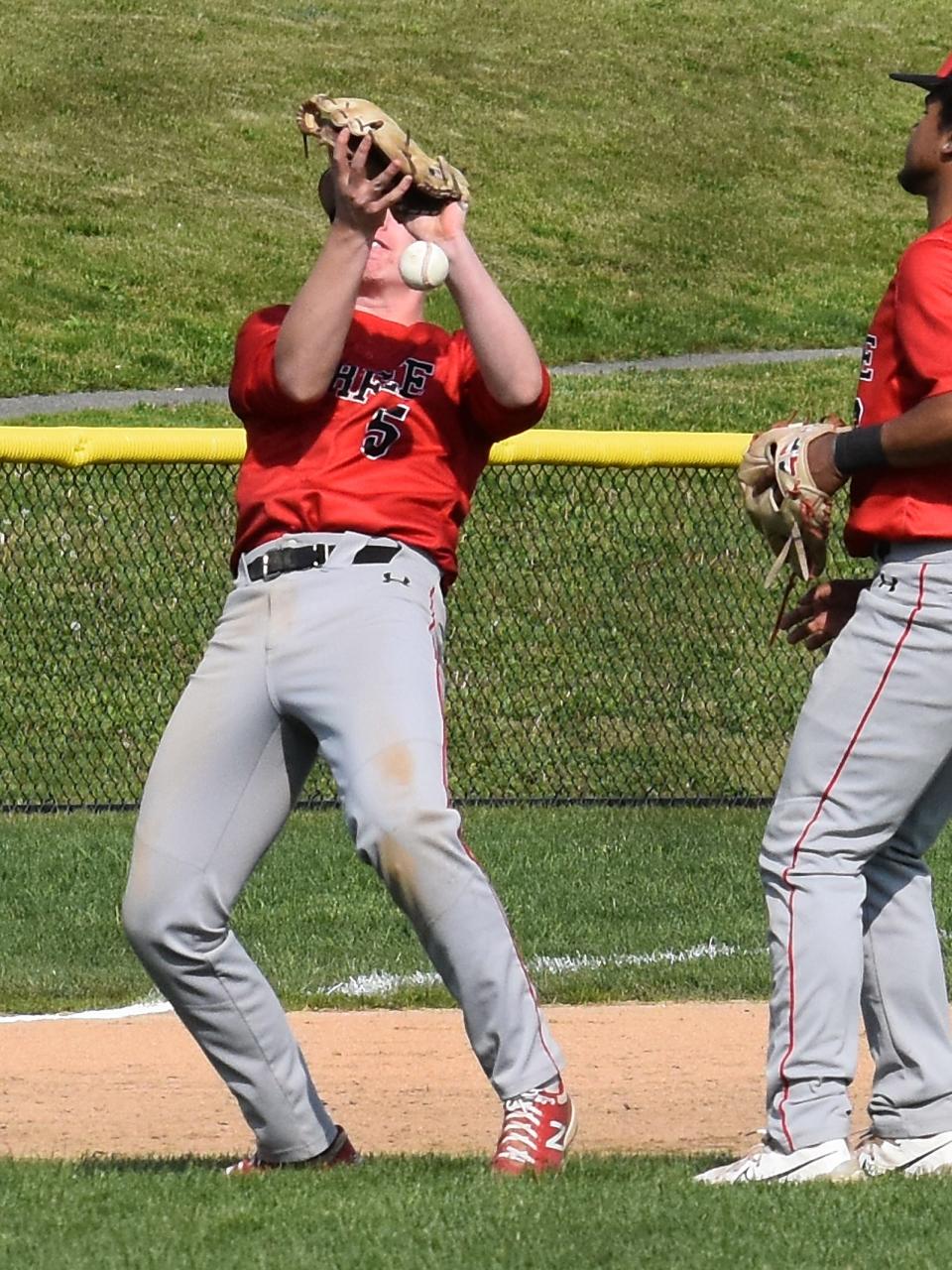 Durfee's Matt Almeida stops a relay from the catcher at third base in front of teammate Jeyden Espinal.