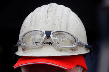 A man wears a helmet with glasses attached during a Thyssenkrupp steel workers protest rally in Bochum, Germany, September 22, 2017, against the planned combination of the group's European steel operations with those of Tata Steel. REUTERS/Wolfgang Rattay