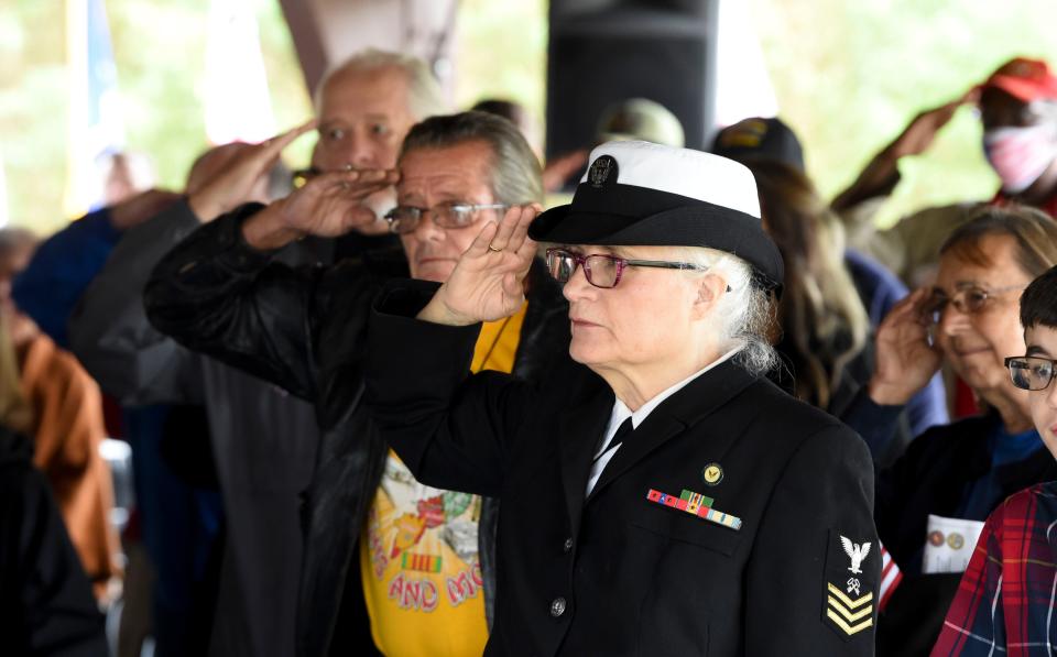 Nov 11, 2022; Tuscaloosa, AL, USA; Veterans salute the flag as the National Anthem is played during the annual observance of Veterans Day in Tuscaloosa Friday, Nov. 11, 2022. 