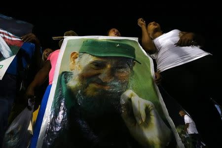 People display an image of former Cuban leader Fidel Castro at a tribute to Castro in Santiago de Cuba, Cuba, December 3, 2016. REUTERS/Ivan Alvarado